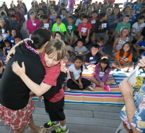 Alick greeting Ms. Rosen with lei